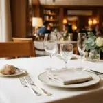 A meticulously set restaurant table viewed from a diner's perspective